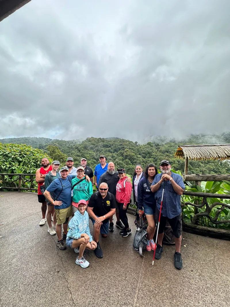 The same group gathered again on the lookout, some of them kneeling in front.